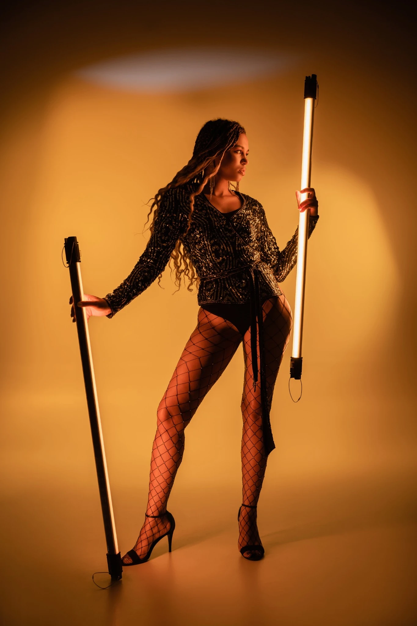 Scandal performer under warm golden stage lights